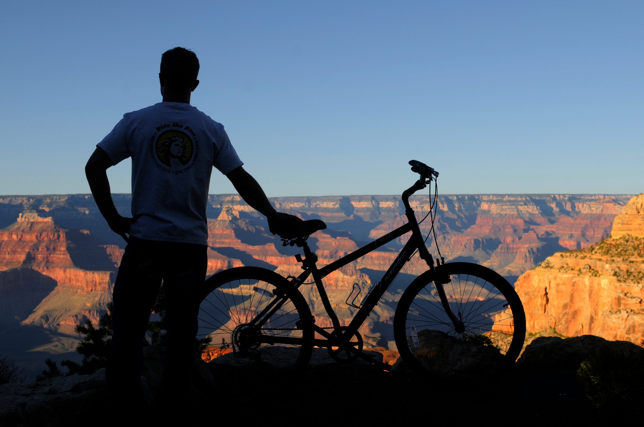 Male Biker over looking the Grand Canyon at sunrise.