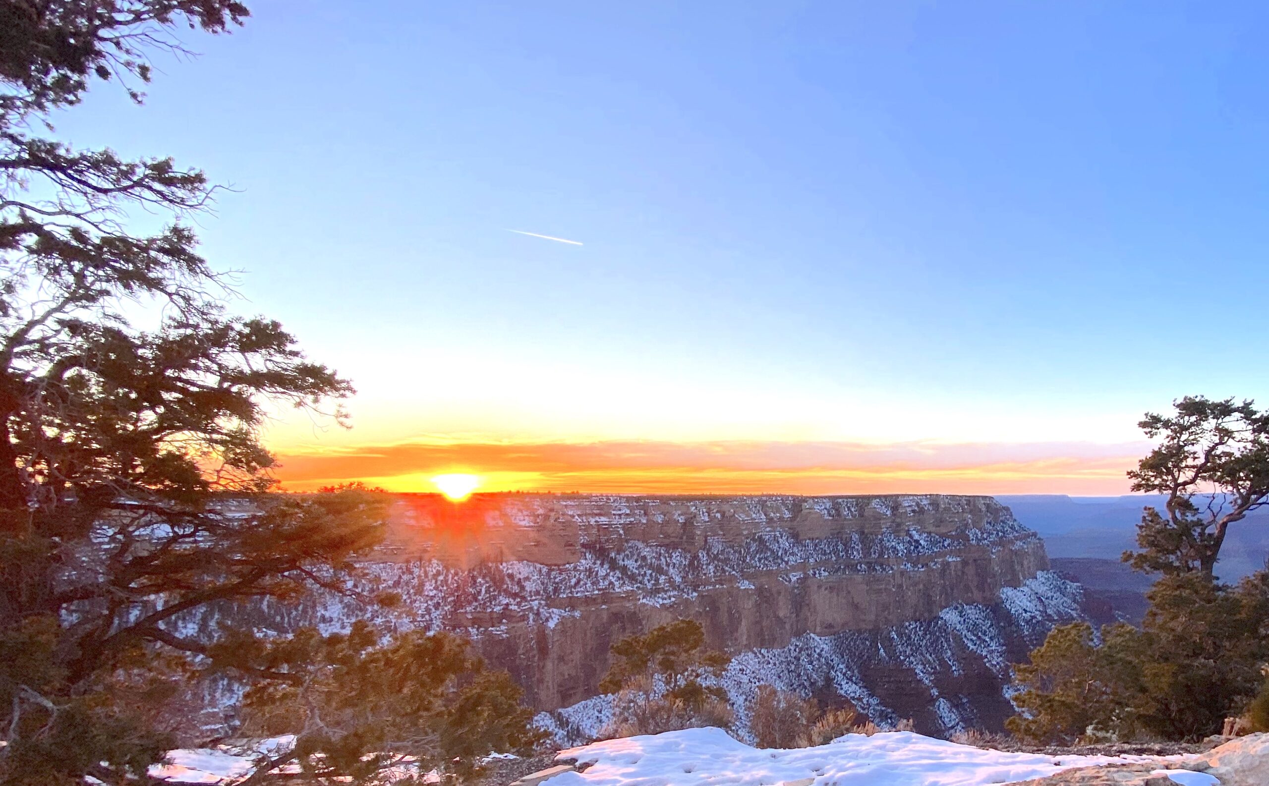 Winter Grand Canyon view as the sunrise is sky lining across the top of the canyon.